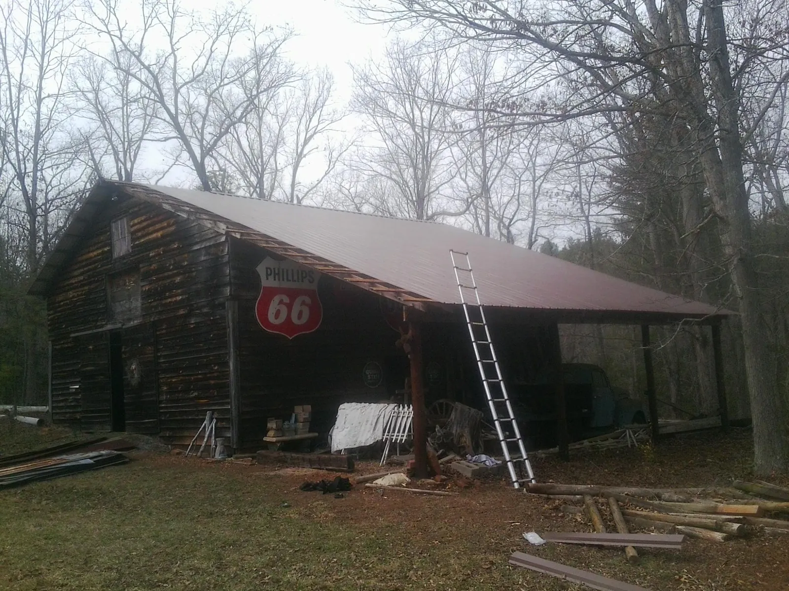 New metal roof on an open sided timber barn with a vintage sign in Spring Valley