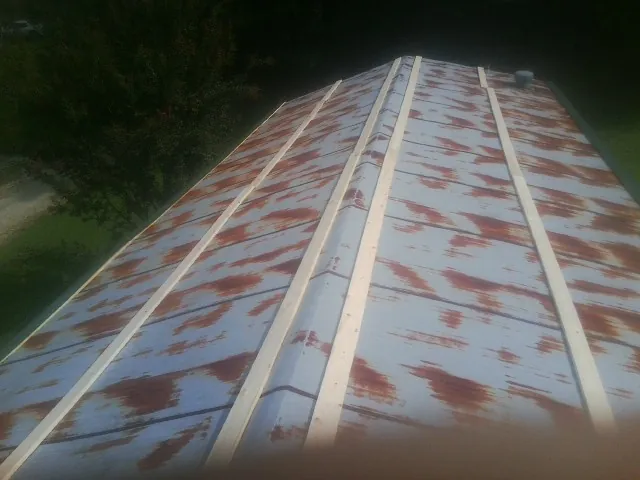 Rusted metal roof panels with new wood purlins before replacement — Storm Damage Roof Repair in Spring Valley by Roofing Brothers